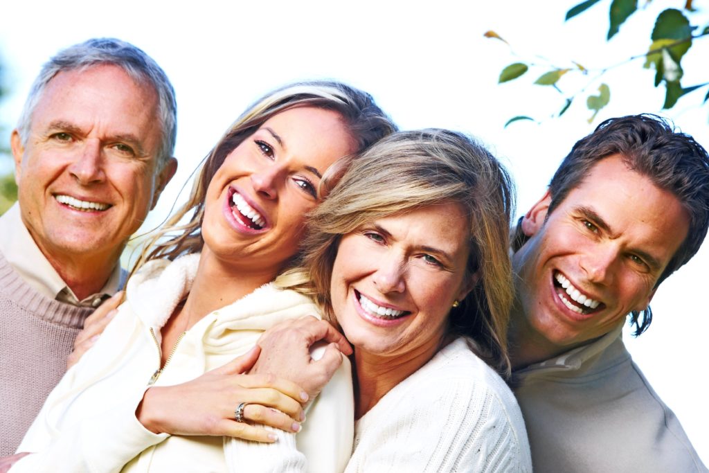 Happy family in park. Father, mother, son and daughter