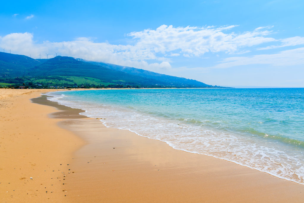 Sandy Paloma beach and mountains in background, Costa de la Luz, Spain