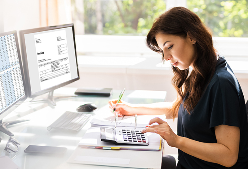 Accountant Using E Invoice Software At Computer In Office